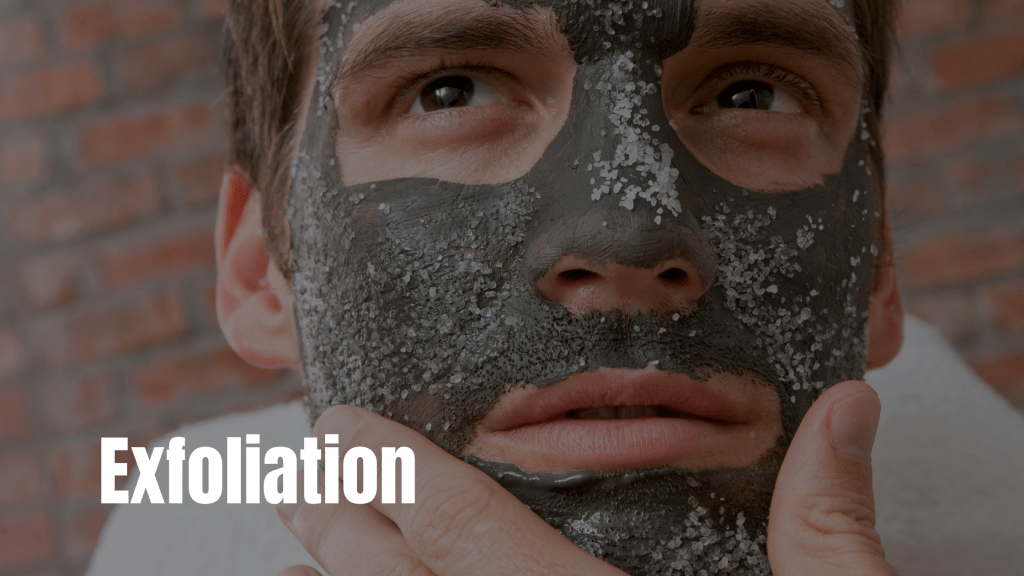"Close-up of a man with a charcoal exfoliating facial mask, highlighting the importance of exfoliation in men's skincare routines for Epicorium skincare guide."